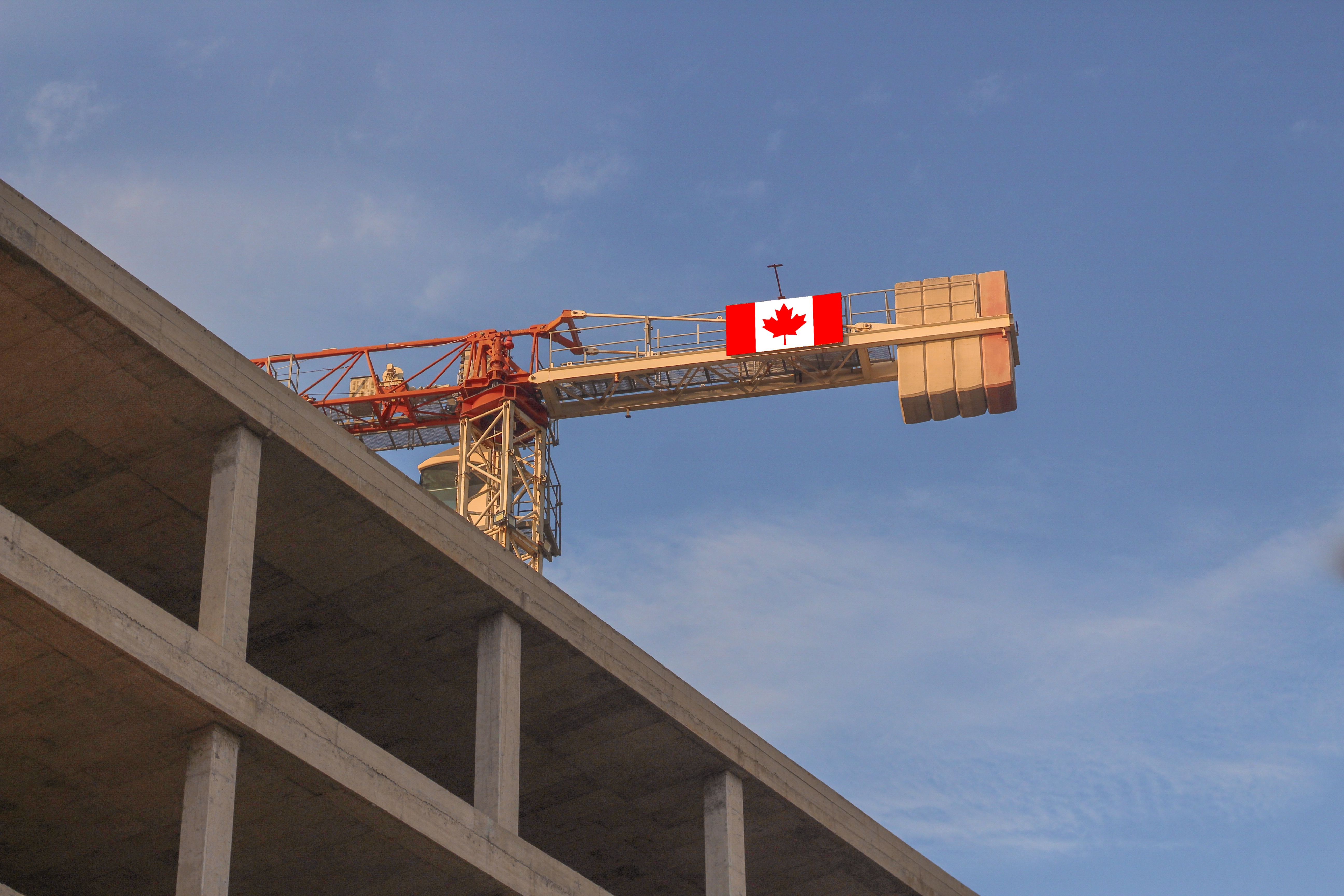 Construction site with crane showing Canadian flag